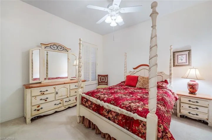 Carpeted bedroom with ceiling fan