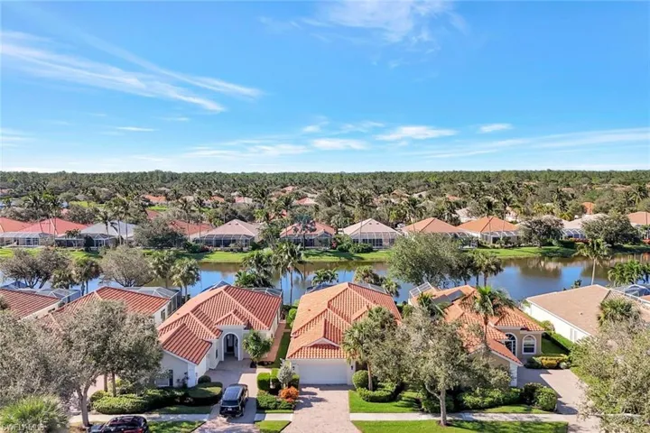 Birds eye view of property with a water view