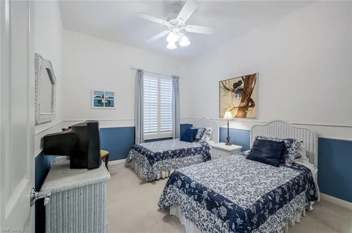 Carpeted bedroom with ceiling fan