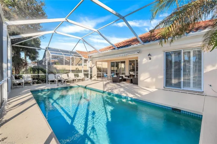 View of pool with a lanai, a patio area, and an outdoor hangout area