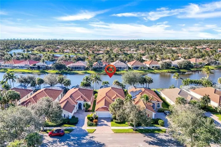 Birds eye view of property with a water view