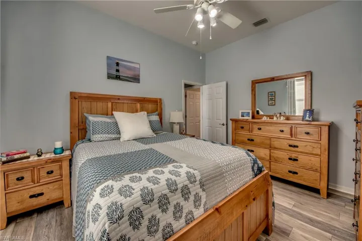 Bedroom with ceiling fan and light wood-type flooring