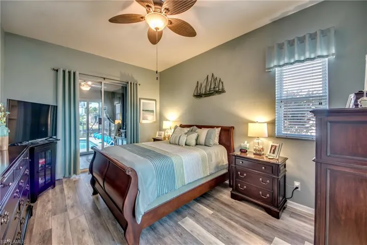 Bedroom featuring access to outside, ceiling fan, and light hardwood / wood-style floors