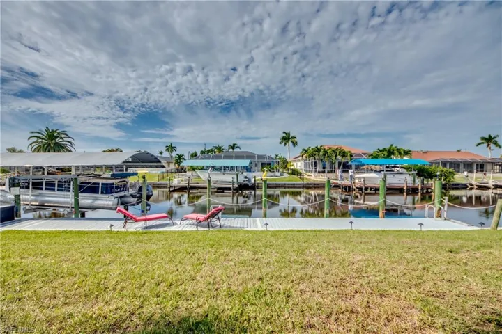 Dock area featuring a lawn and a water view