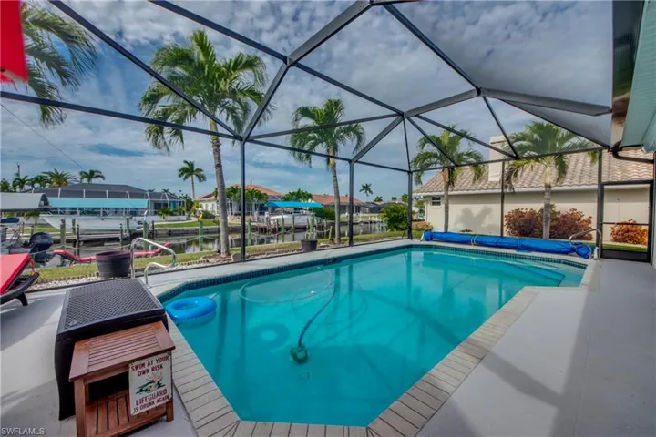 View of swimming pool featuring a lanai and a water view