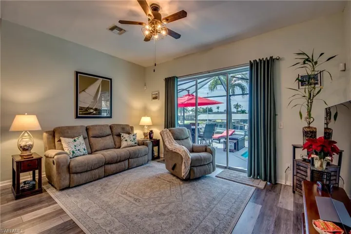 Living room featuring ceiling fan and hardwood / wood-style floors