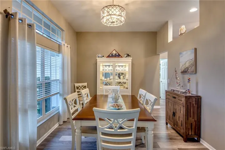 Dining room featuring wood-type flooring and a chandelier