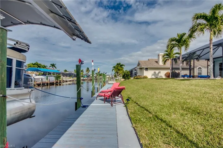 Dock area featuring a yard and a water view