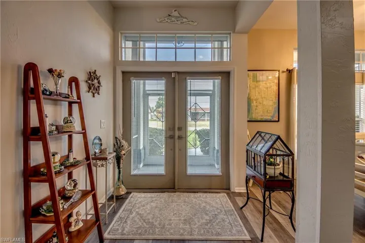 Doorway to outside with french doors and wood-type flooring