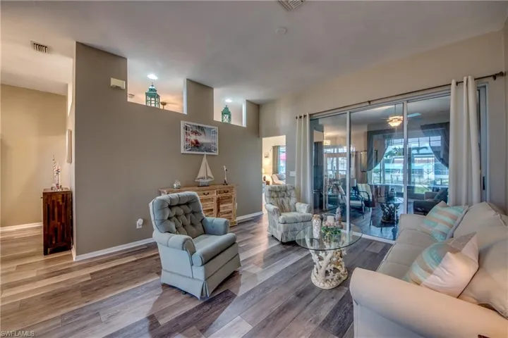 Living room with hardwood / wood-style flooring and ceiling fan
