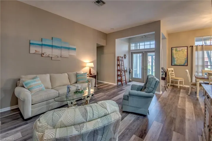 Living room with hardwood / wood-style floors and french doors