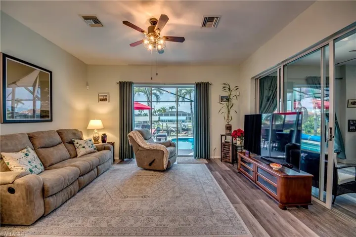 Living room with hardwood / wood-style floors and ceiling fan