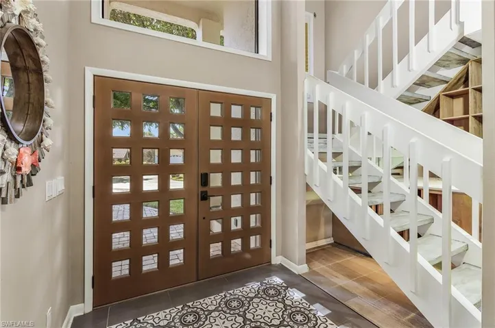 Tiled foyer featuring a high ceiling
