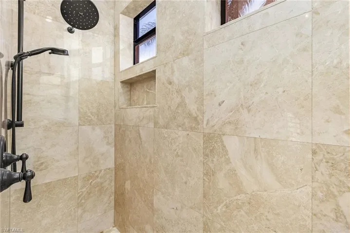 Interior details featuring a tile shower