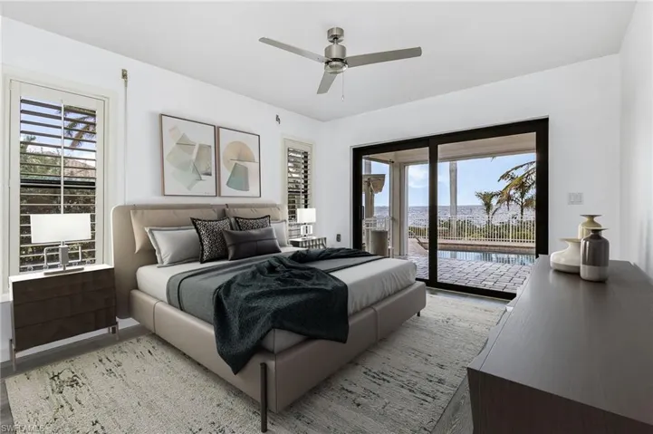 Bedroom with ceiling fan, access to outside, and multiple windows