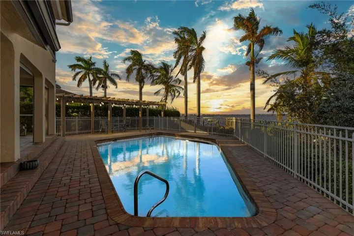 Pool at dusk with a patio