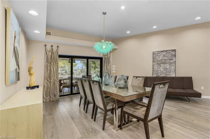 Dining area featuring a notable chandelier and light wood-type flooring