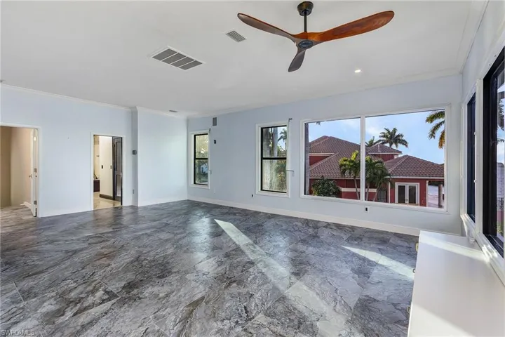 Spare room with crown molding and ceiling fan