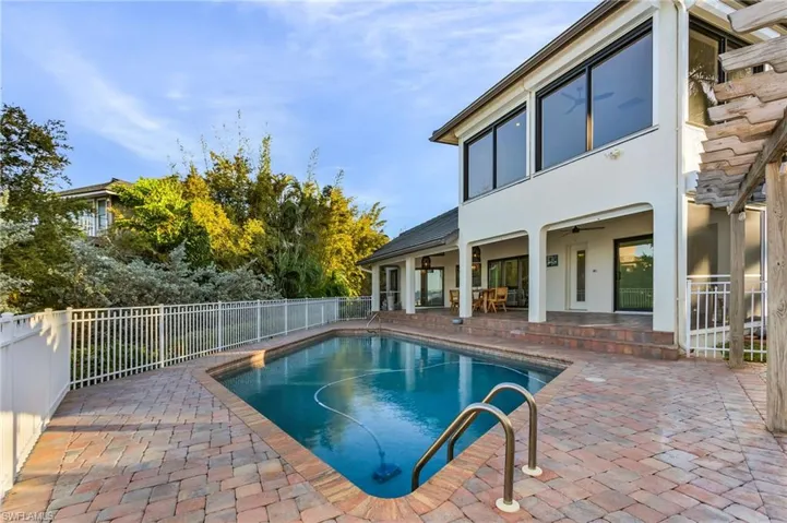 View of swimming pool featuring ceiling fan and a patio area