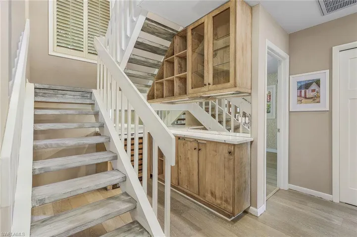 Stairs with hardwood / wood-style flooring