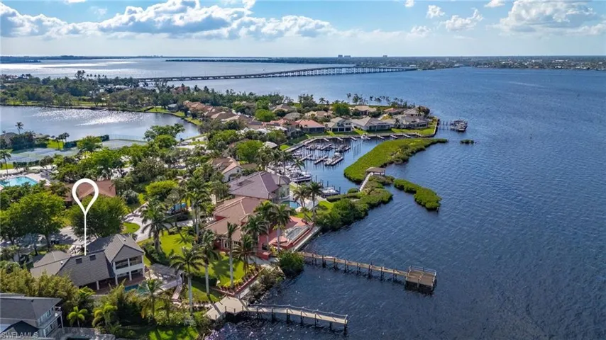 Birds eye view of property with a water view