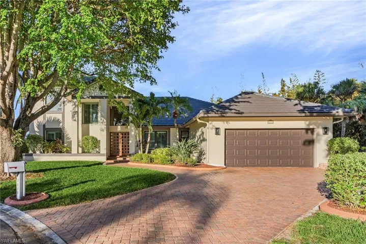 View of front of home featuring a front yard and a garage
