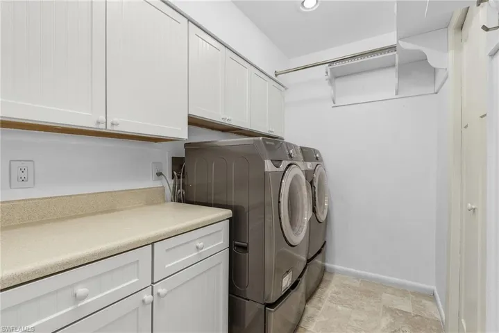 Washroom featuring cabinets and independent washer and dryer