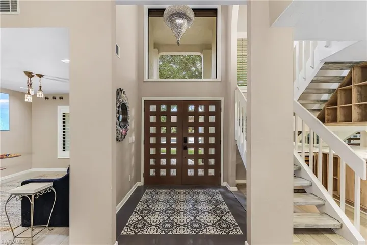 Foyer featuring light hardwood / wood-style floors and an inviting chandelier