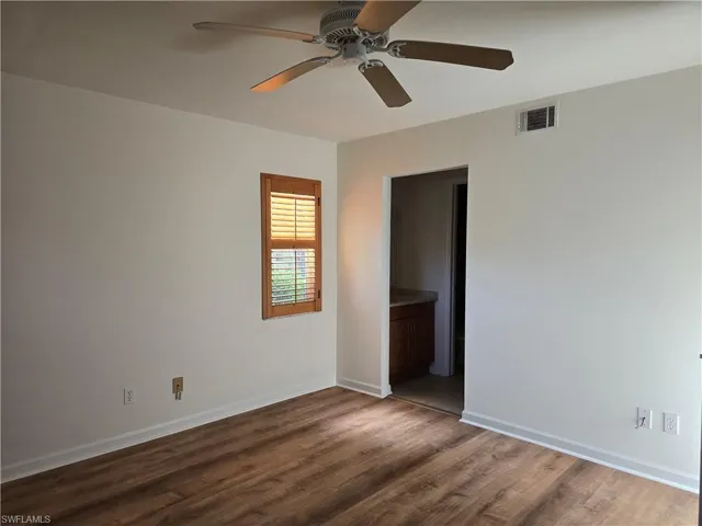 Master bedroom featuring dark hardwood / wood-style flooring and ceiling fan