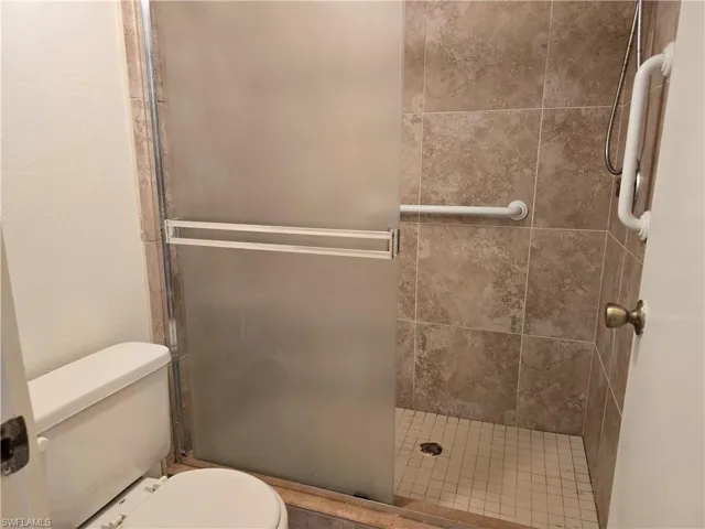 Bathroom with an enclosed shower and toilet