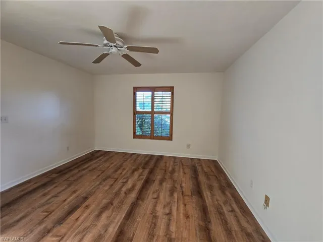 Master bedroom featuring dark hardwood / wood-style floors and ceiling fan