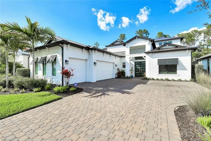 Brick-paver drive leading to 3-car garage