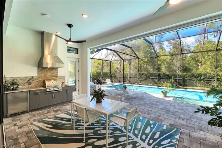 Custom built-in kitchen on lanai with grill and refrigerator