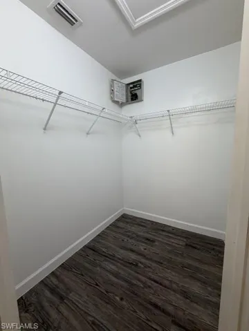 Interior space featuring wood-finish flooring, white baseboards, and white walls