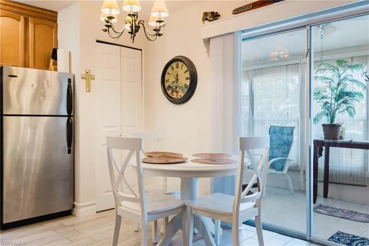 Dining area with light-toned flooring and a chandelier light fixture