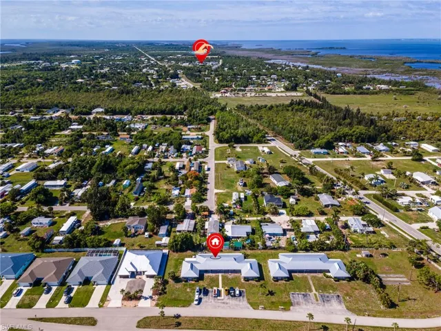Aerial perspective showcasing the surrounding landscape with residential properties and natural areas