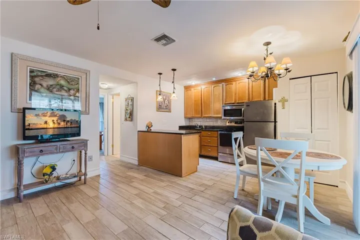 Open-concept living space featuring wood-look tile flooring and recessed lighting