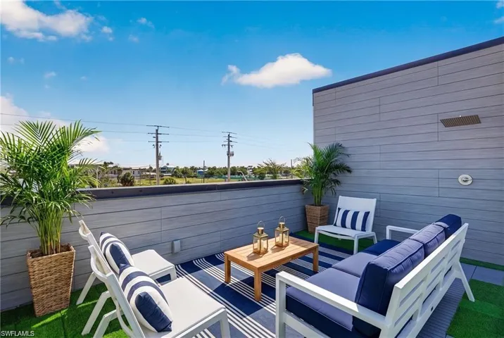 71 Mango North Unit Rooftop Terrace - featuring composite decking, artificial turf, and a built-in outdoor shower