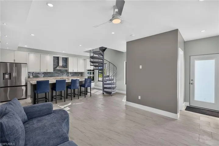 71 Mango Unit 1 Open-concept living area living area featuring a modern kitchen with a large island, stainless steel appliances, and light cabinetry