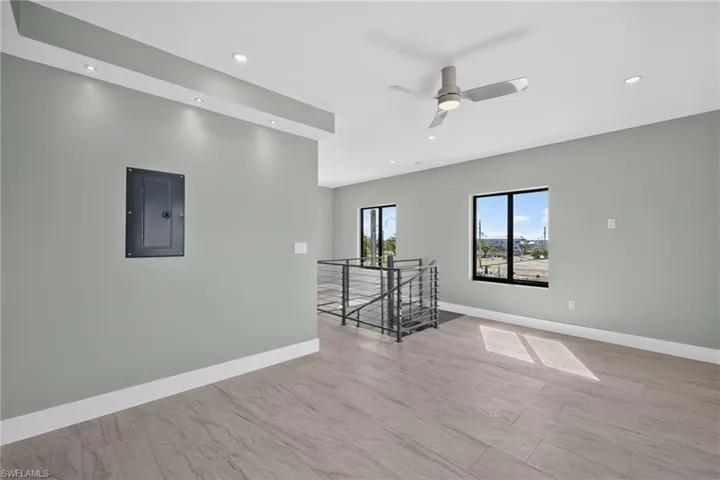 71 Mango South Unit Bedroom Unfurnished Spacious room featuring wood-finish flooring, recessed lighting, a ceiling fan, and large windows