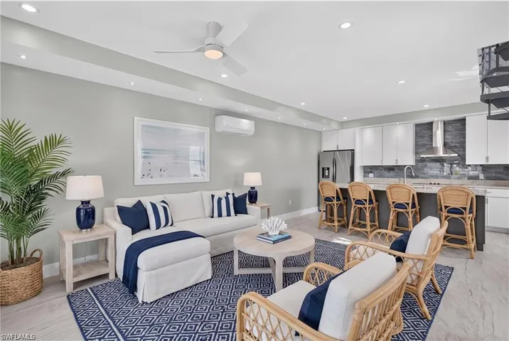 71 Mango south unit: Open-concept living space featuring wood-finish flooring, recessed lighting, and a ceiling fan  - VIRTUALLY STAGED