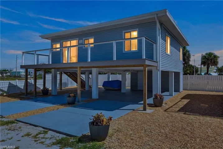 2101 Cottage Elevated construction featuring blue horizontal siding and white trim