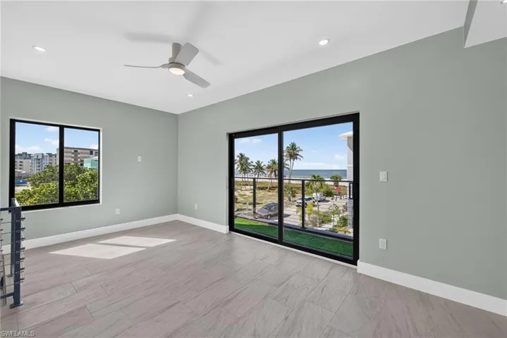 71 Mango Unit 2 bedoom with expansive sliding glass doors opening to a balcony with glass railing