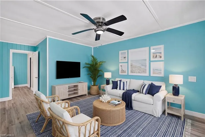 2101 Cottage North Unit - Recessed lighting and a ceiling fan fixture illuminate the living area- VIRTUALLY STAGED