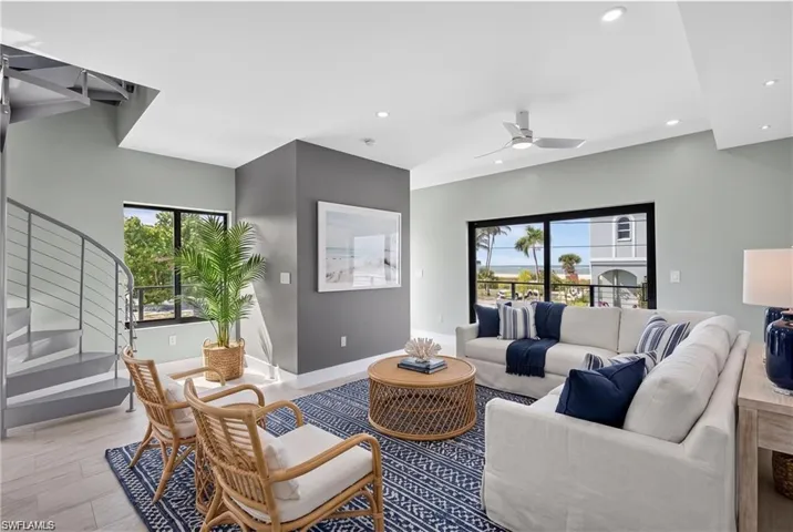 71 Mango South Unit: Spacious living area featuring light-toned walls, wood-finish flooring, and recessed lighting - VIRTUALLY STAGED