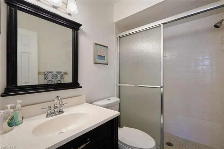 Full bath with vanity and a stall shower