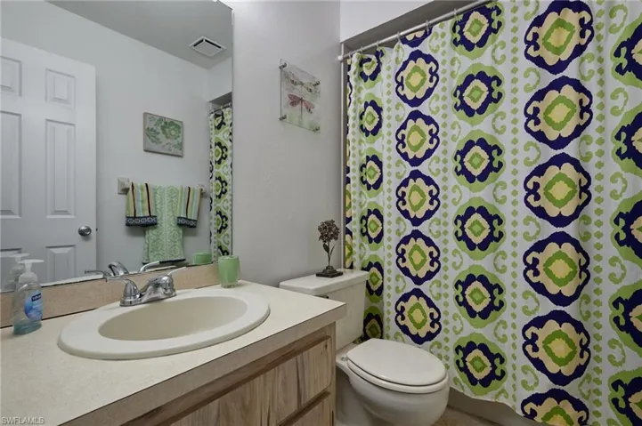 Full bathroom with a shower with shower curtain and vanity