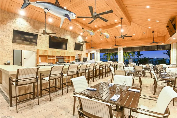 View of patio / terrace featuring ceiling fan and exterior bar