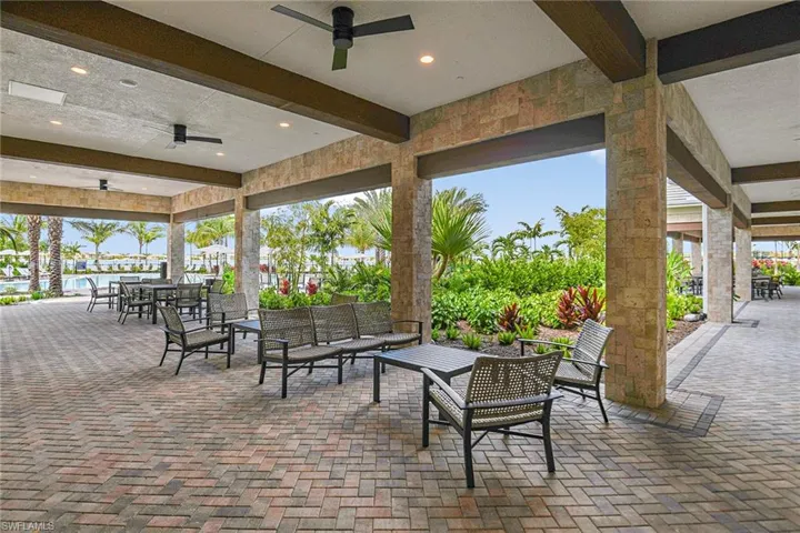 View of patio with outdoor lounge area, ceiling fan, and a water view
