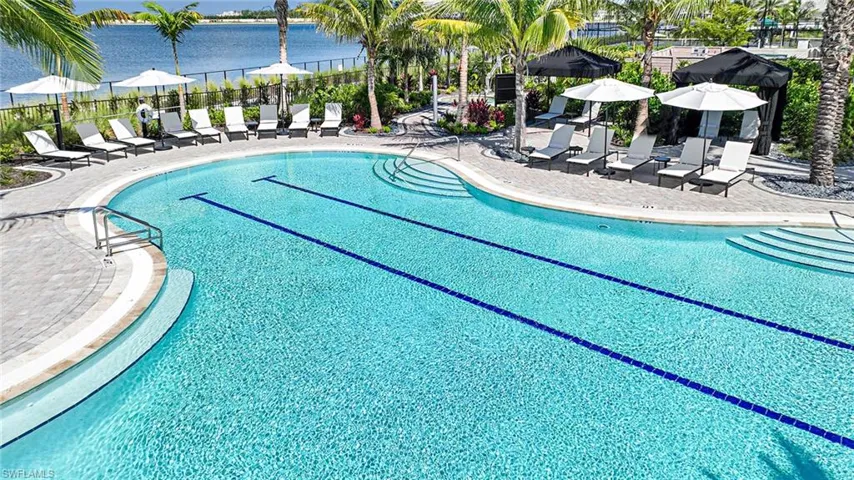 View of swimming pool with a patio area and a water view